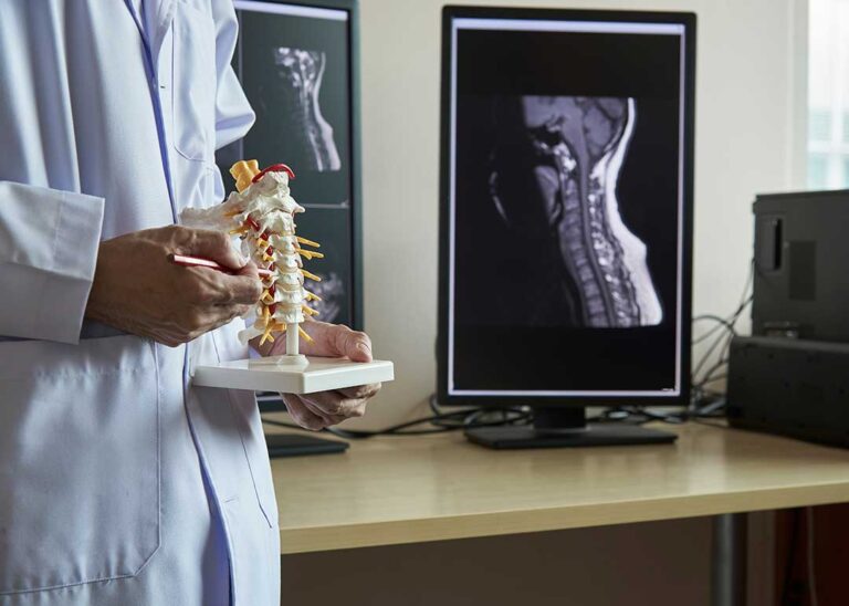 A young child receiving a gentle chiropractic assessment from a professional with a parent present.